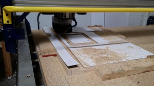 The top of my new router table being precision milled on the ShopBot at X-Laser.  